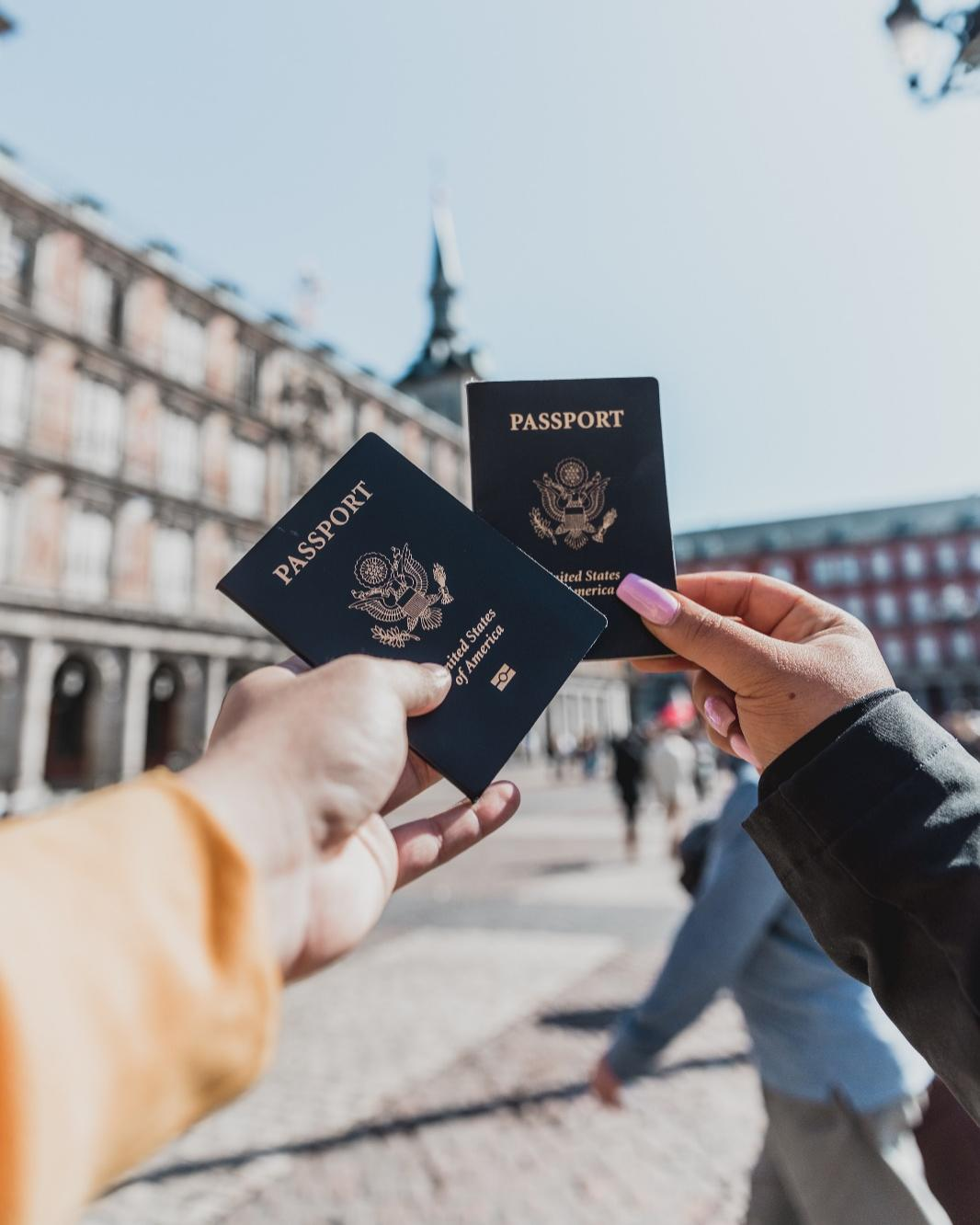 Two persons showing their passports