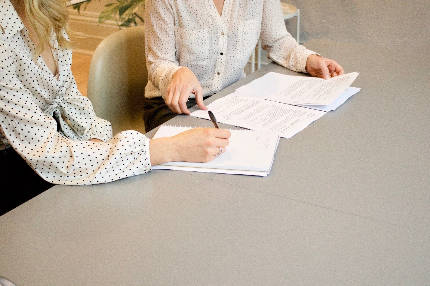 Two persons working on some documents