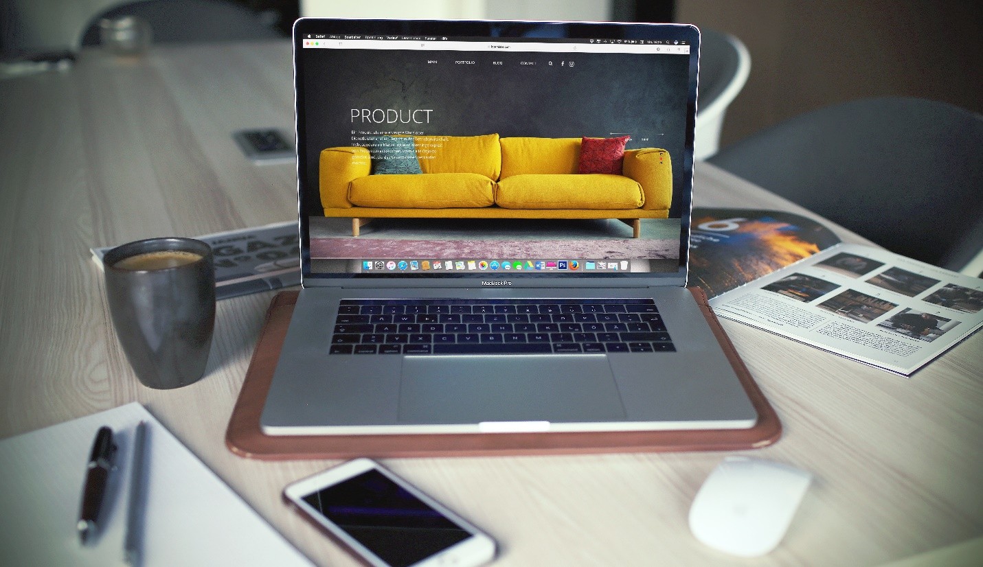 A laptop, a mobile phone, and a coffee mug on a table